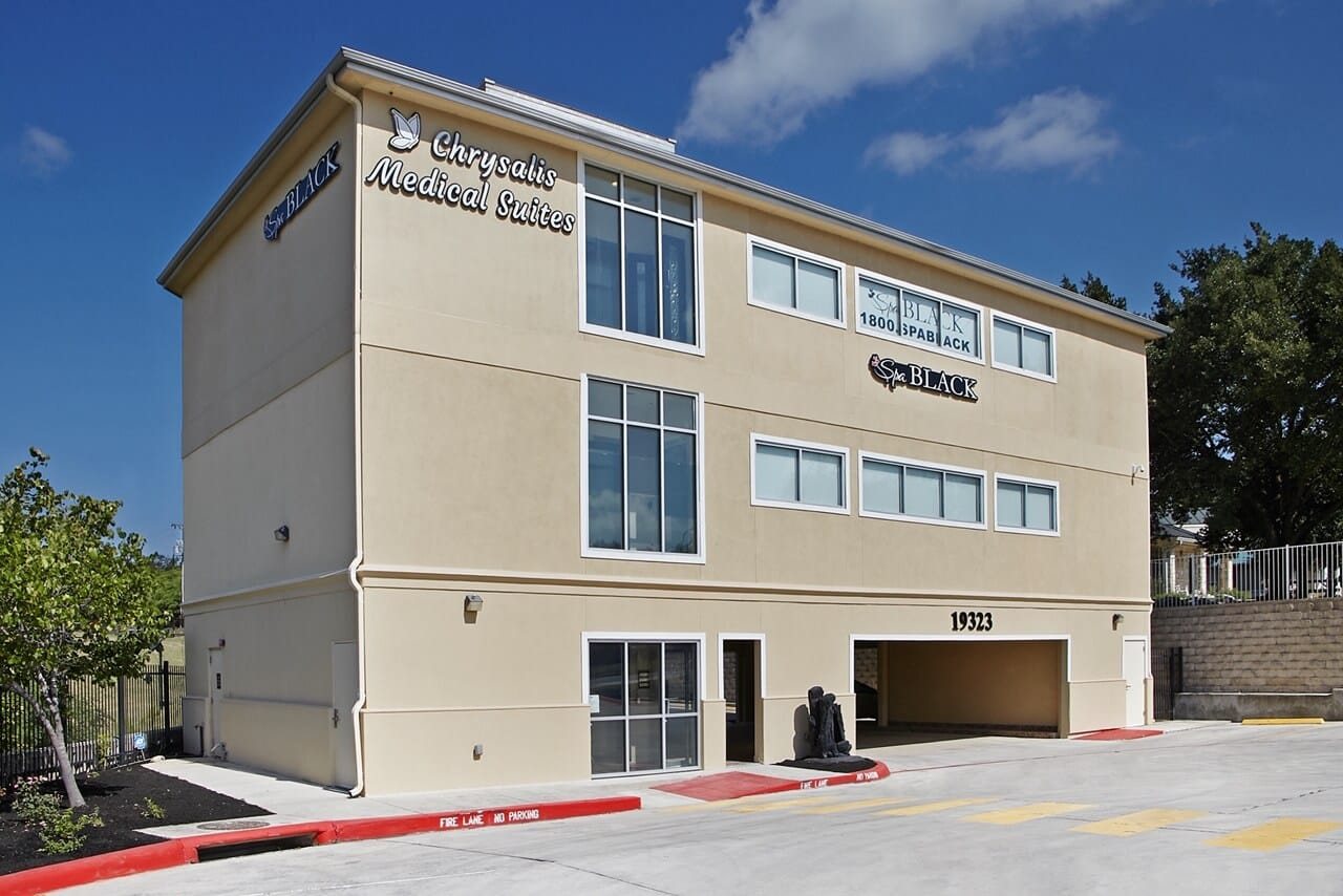 The three-storey building at 19323 Stone Oak Parkway with Spa Black signage